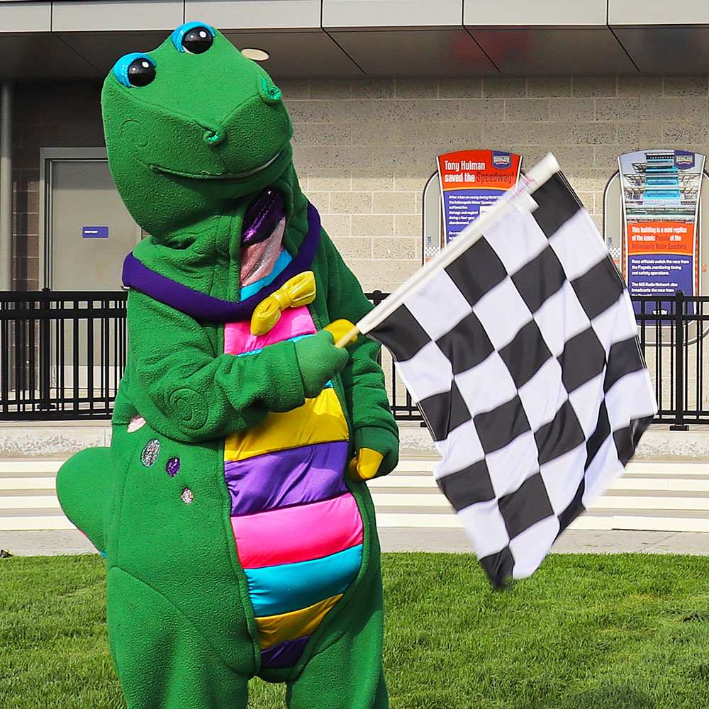 Rex standing outside holding a black and white checkered flag